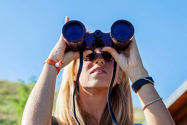 istock pretty girl with binoculars looking at the horizon 489258292