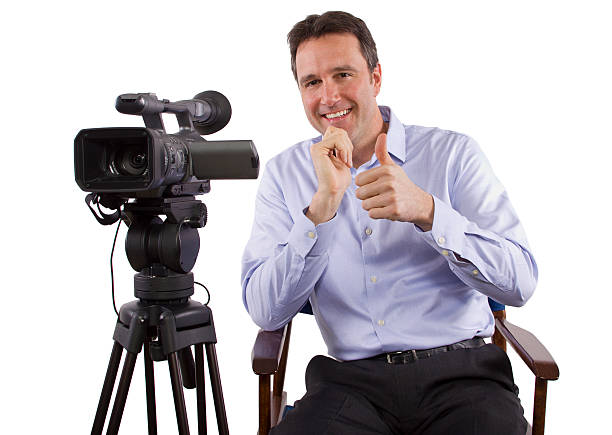 Casting Director Sitting on a Chair with a Camera casting director sitting and recording auditions with camera celebrity endorsements stock pictures, royalty-free photos & images