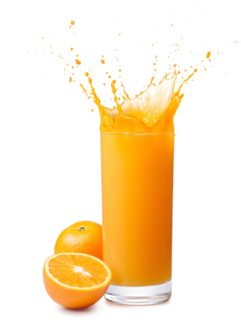 glass of splashing orange juice with its fruits