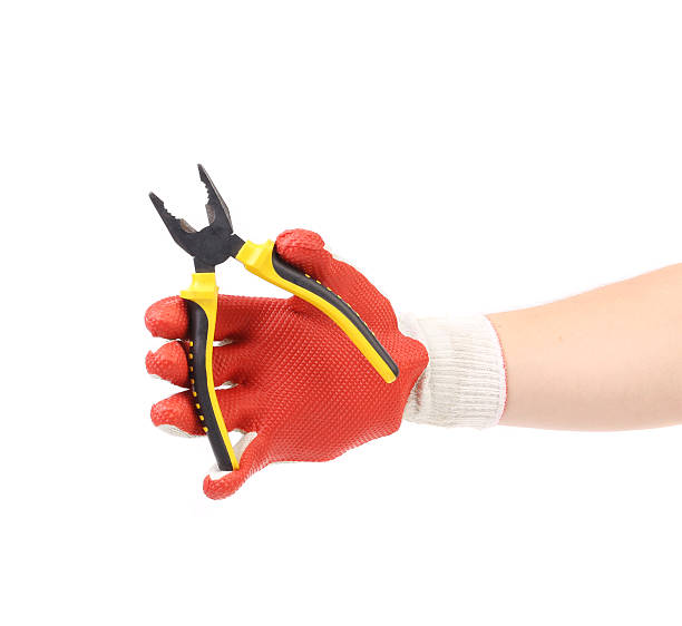 istock Hand in gloves holding pliers. 489268349