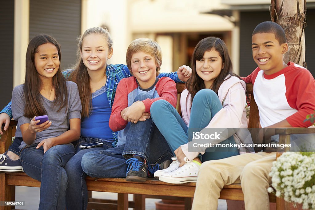 Group Of Children Sitting On Bench In Mall Group Of Children Sitting On Bench In Mall Smiling To Camera Child Stock Photo