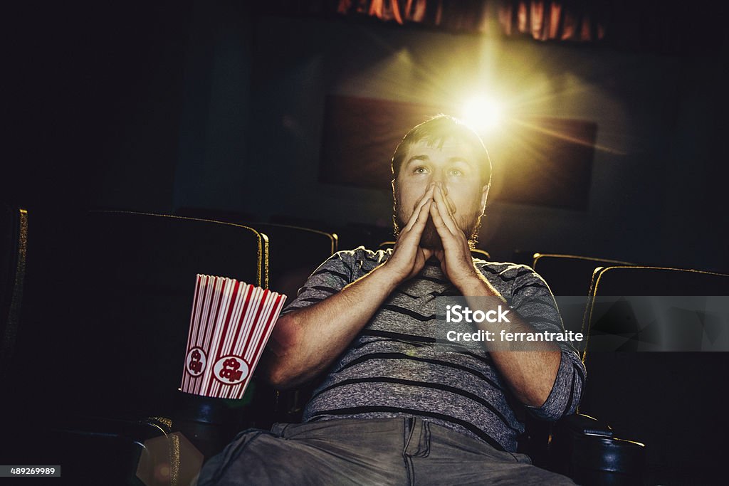 Lone man at the movies Lone man in a movie theater Critic Stock Photo