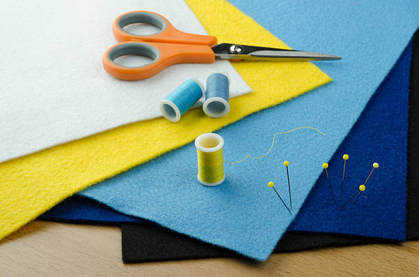 felt plates for handicraft with handicraft tools. Needles, yarn, scissor...