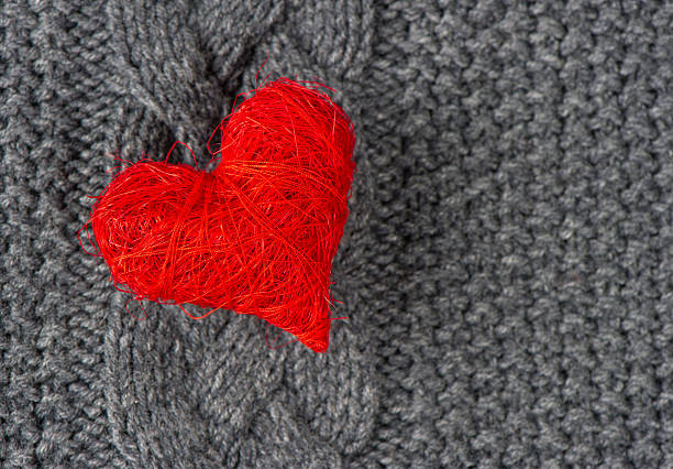 istock red heart of knitted wool background 489274419