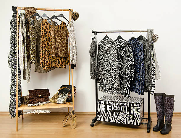 istock Dressing closet with animal print clothes arranged on hangers. 489274479