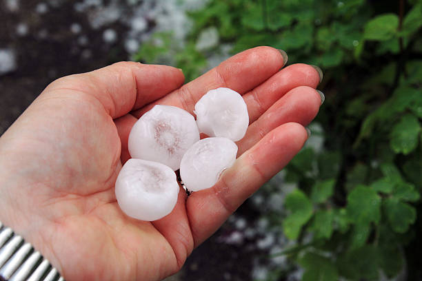 big hailstones - moving toward hailing human hand here стоковые фото и изображения