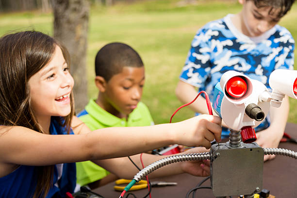 istock Little engineers!  Ethnic elementary children collaborate on 'robot' they created. 489274777