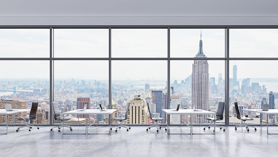 Workplaces in a modern panoramic office, New York city view in the windows, Manhattan. Open space. White tables and black leather chairs. A concept of financial consulting services. 3D rendering.