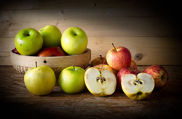 istock Apple and basket on wooden table, Still Life Style 489301360