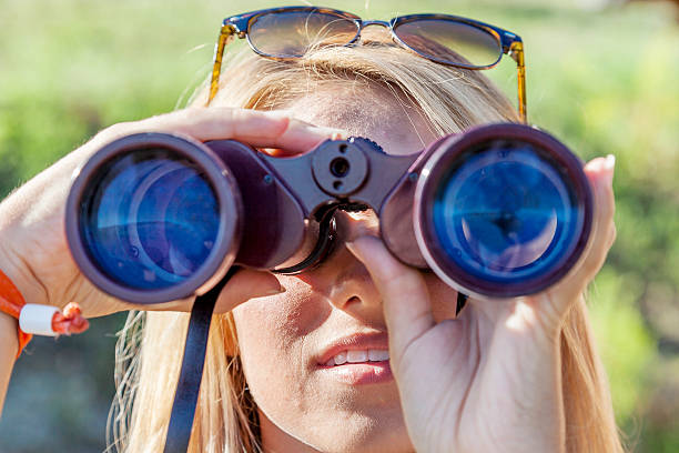 istock pretty girl with binoculars looking at the horizon 489301998