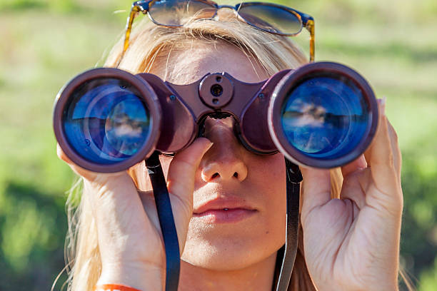 istock pretty girl with binoculars looking at the horizon 489302372