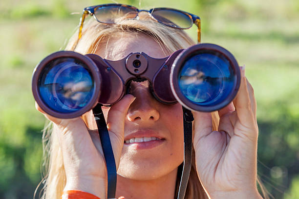 istock pretty girl with binoculars looking at the horizon 489302722