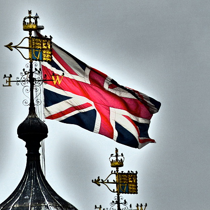 Flag and coat of arms of Great Britain on a textured background. Concept collage.