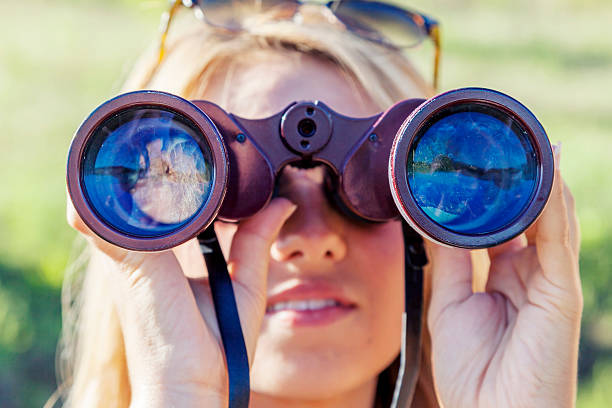 istock pretty girl with binoculars looking at the horizon 489302998