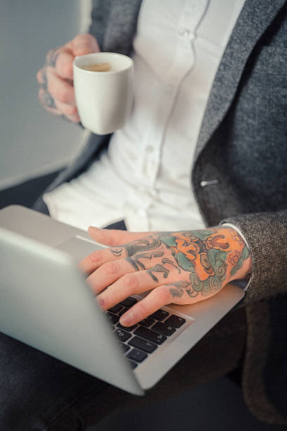 istock Tattoo artist using laptop in studio 489303172