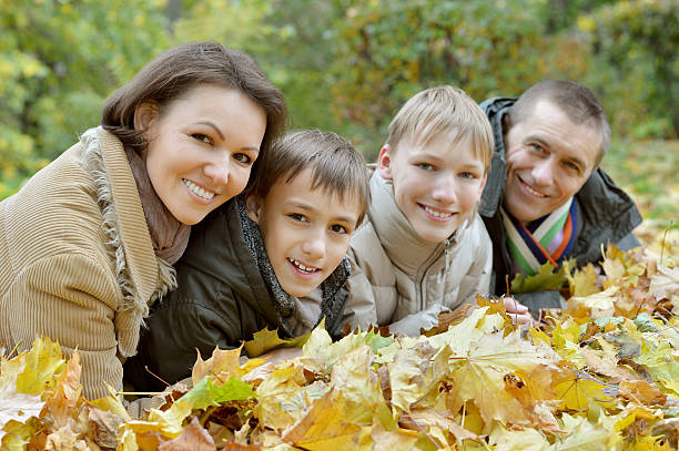 istock Family relaxing in autumn park 489303508