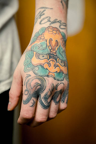 istock Close-up of artist's tattooed hand 489304600