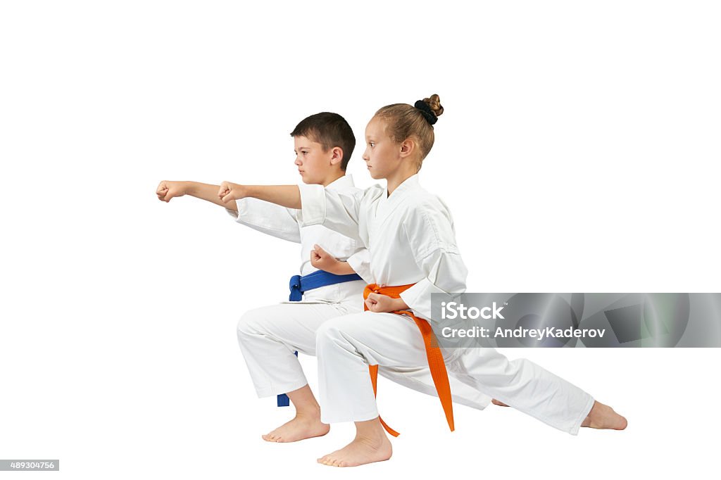 Children are beating the blow gyaku-tsuki in racks of karate Boys Stock Photo