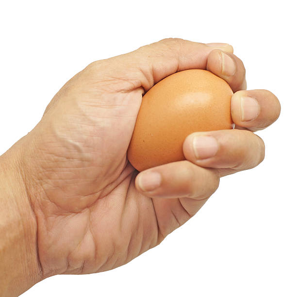 istock egg in male hand isolated on white 489305868