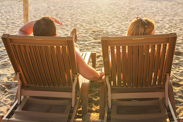 istock couple sitting on the lounge chairs 489307094