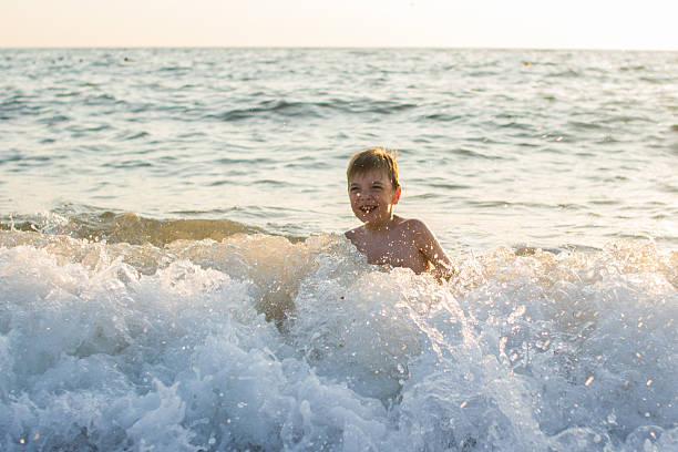 istock kid having fun in the sea 489308608