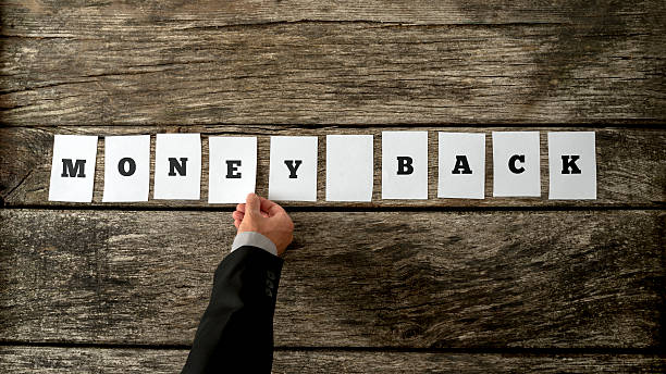 istock Overhead view of salesman assembling a sign Money back 489309556