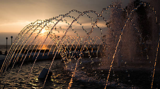 istock City fountain at sunset. 489309862