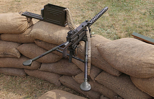 istock machine gun with bullets in the trench war 489310874
