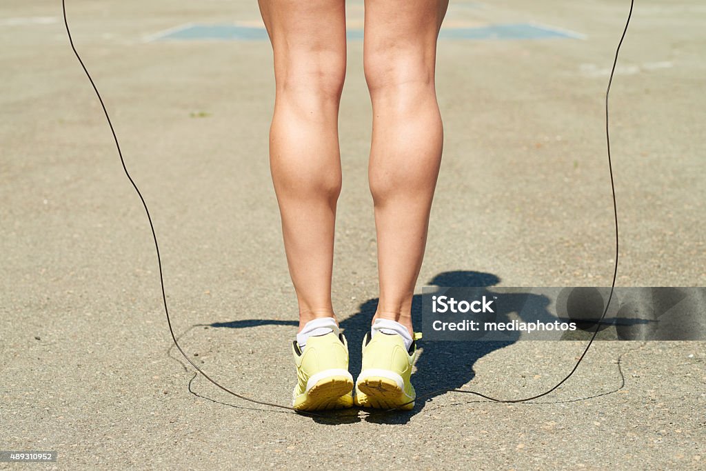 Calf building workout Woman exercising outdoors to strengthen her leg muscles Calf - Human Leg Stock Photo