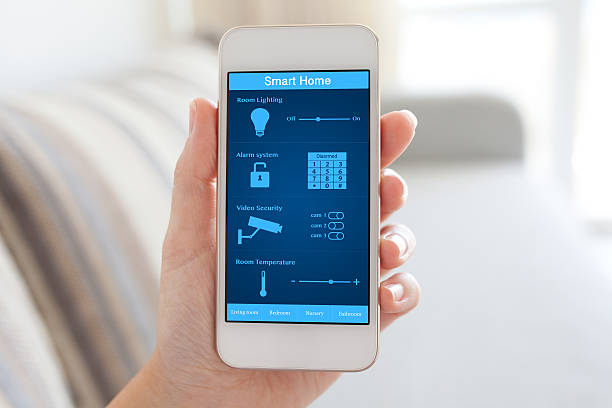 istock female hand holding phone with smart home on the screen 489312238
