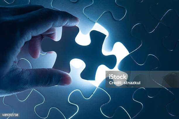 Hand Insert Jigsaw Conceptual Image Of Business Strategy Stock Photo - Download Image Now