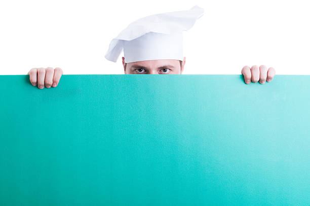 istock Cook or chef looking over green wall with advertising space 489313606