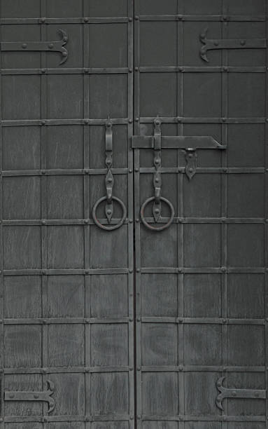 istock Old black metal gate taken closeup. 489316036