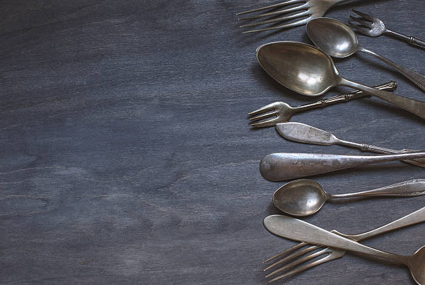 istock antique cutlery on wooden background 489338064