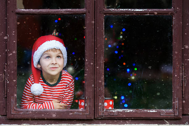 istock Two cute boys, brothers, looking through window, waiting Santa 489338356