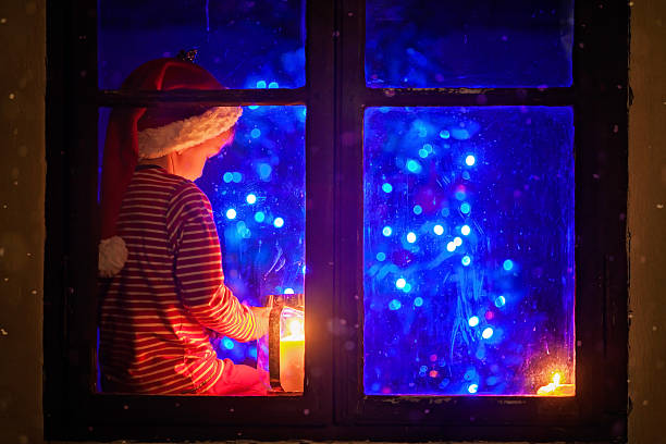 istock Cute boy, sitting on window shield, playing on mobile phone 489339018