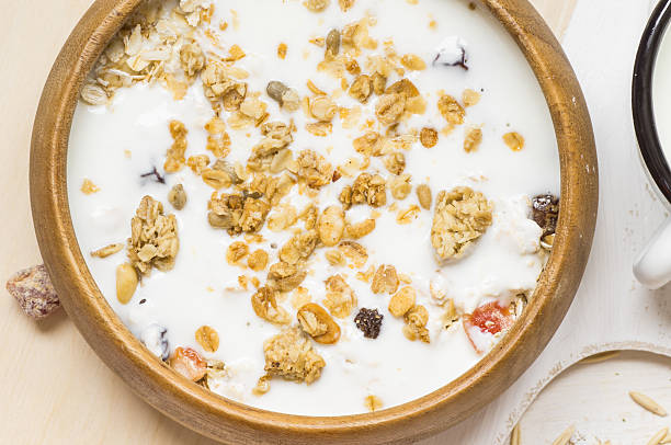 istock Muesli with milk in a rustic wooden bowl 489339580