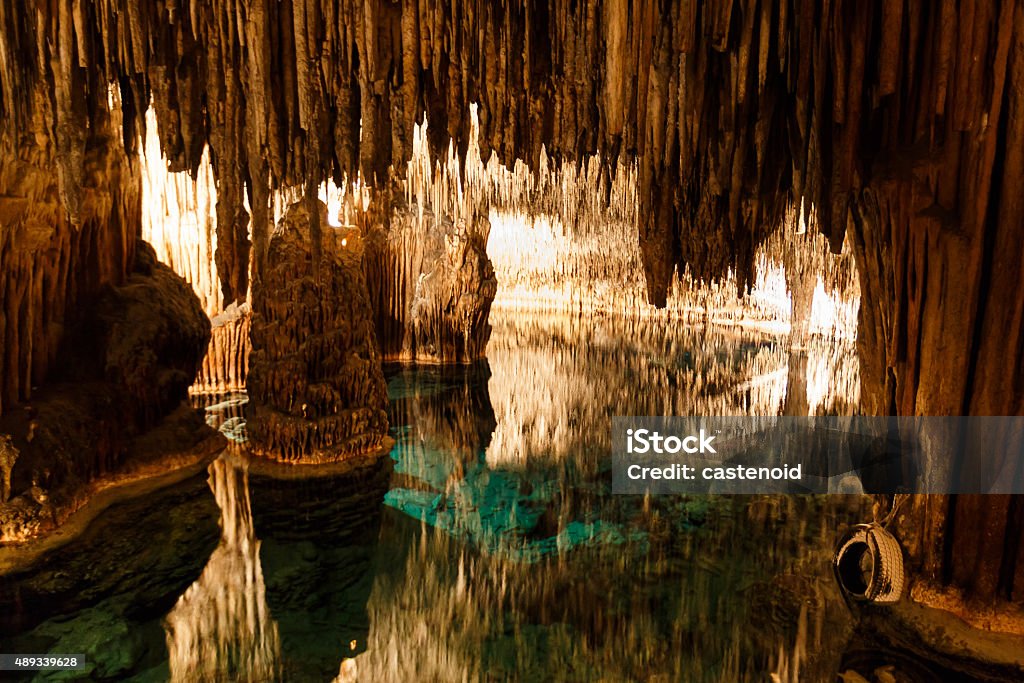 Caves of Drach with reflection in water Caves of Drach with many stalagmites and stalactites. Mallorca, Spain Cave Stock Photo