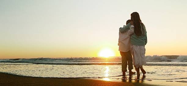 istock Boy And Girl Playing Ocean Sunrise 489343466