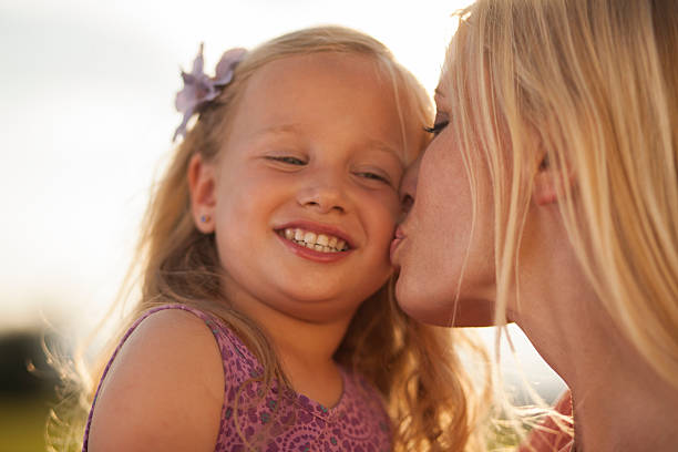 istock Mother kissing her daughter 489343488