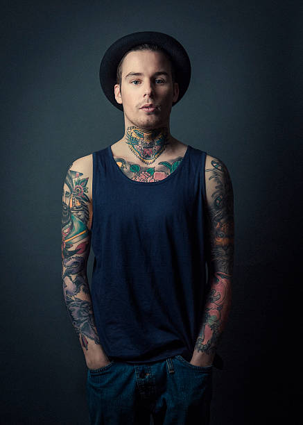 istock Confident tattooed man with hands in pockets 489343582