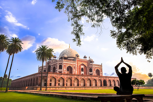 A man doing Yoga on the lawns of Humayun’s Tomb during the Early morning. 
