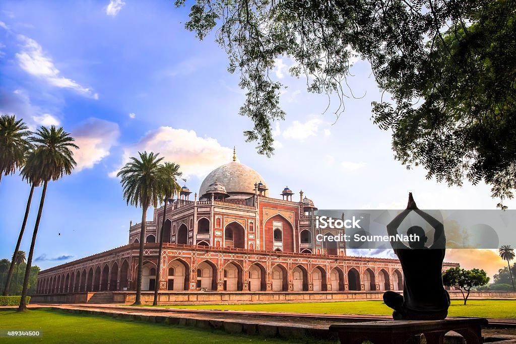 Yoga at Humayun’s Tomb, Delhi, India - CNGLTRV1109 A man doing Yoga on the lawns of Humayun’s Tomb during the Early morning.  New Delhi Stock Photo