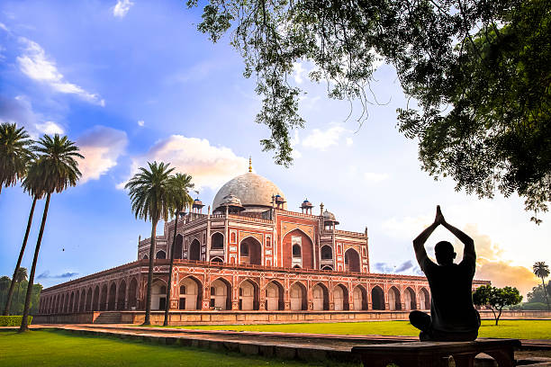 Yoga at Humayun’s Tomb, Delhi, India - CNGLTRV1109 A man doing Yoga on the lawns of Humayun’s Tomb during the Early morning.  dome tent photos stock pictures, royalty-free photos & images