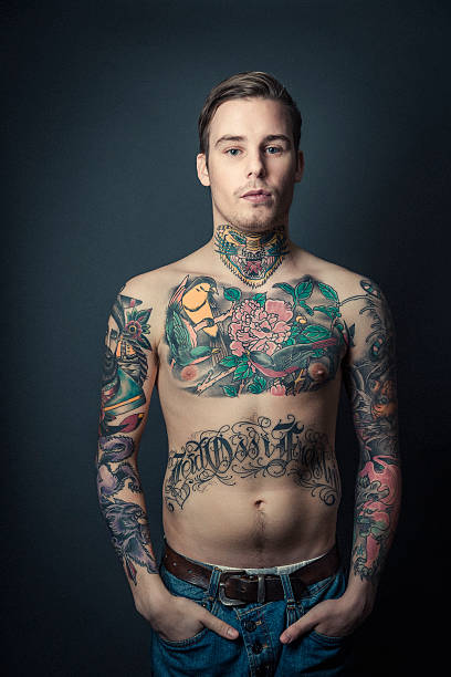 istock Shirtless tattooed man with hands in pockets 489344652