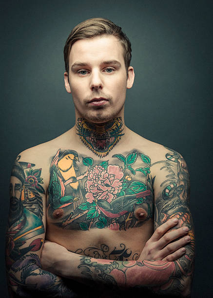 istock Shirtless tattooed man standing arms crossed 489344868