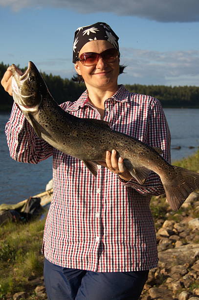 istock Woman caught a big beautiful salmon. 489345052