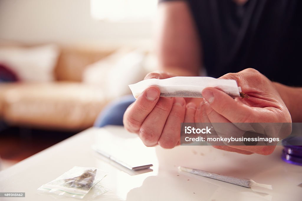 Close Up Of Man Rolling Marijuana Joint At Home Marijuana Joint Stock Photo