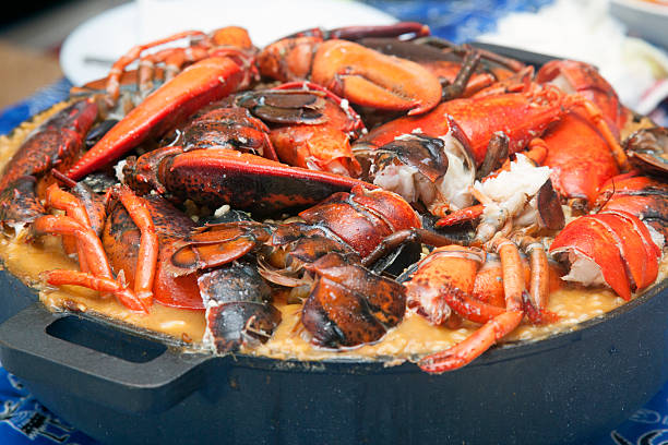 cuisine espagnole la paella l'arroz caldoso - seafood lobster paella prepared shellfish photos et images de collection