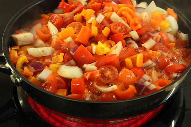 Preparation of cherry tomato sauce. Tomato, onion and oregano fried in olive oil. Spanish Cuisine. Mediterranean cuisine.